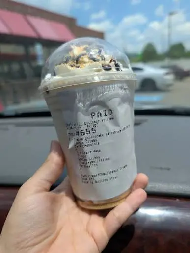 Sheetz Cheezecake Shake in a clear cup with whipped cream, photographed at the in-store kiosk counter